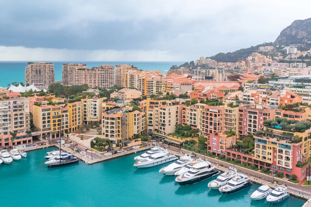 Aerial view of Monaco's marina with yachts berthed.