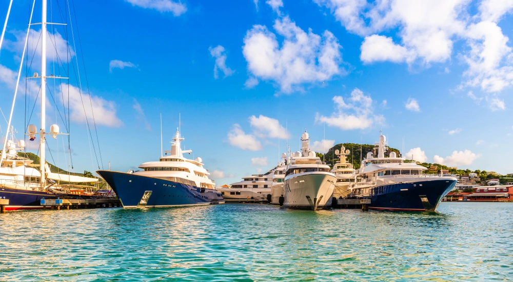 Multiple yachts docked in Saint Martin/Sint Maarten on a sunny day over blue water