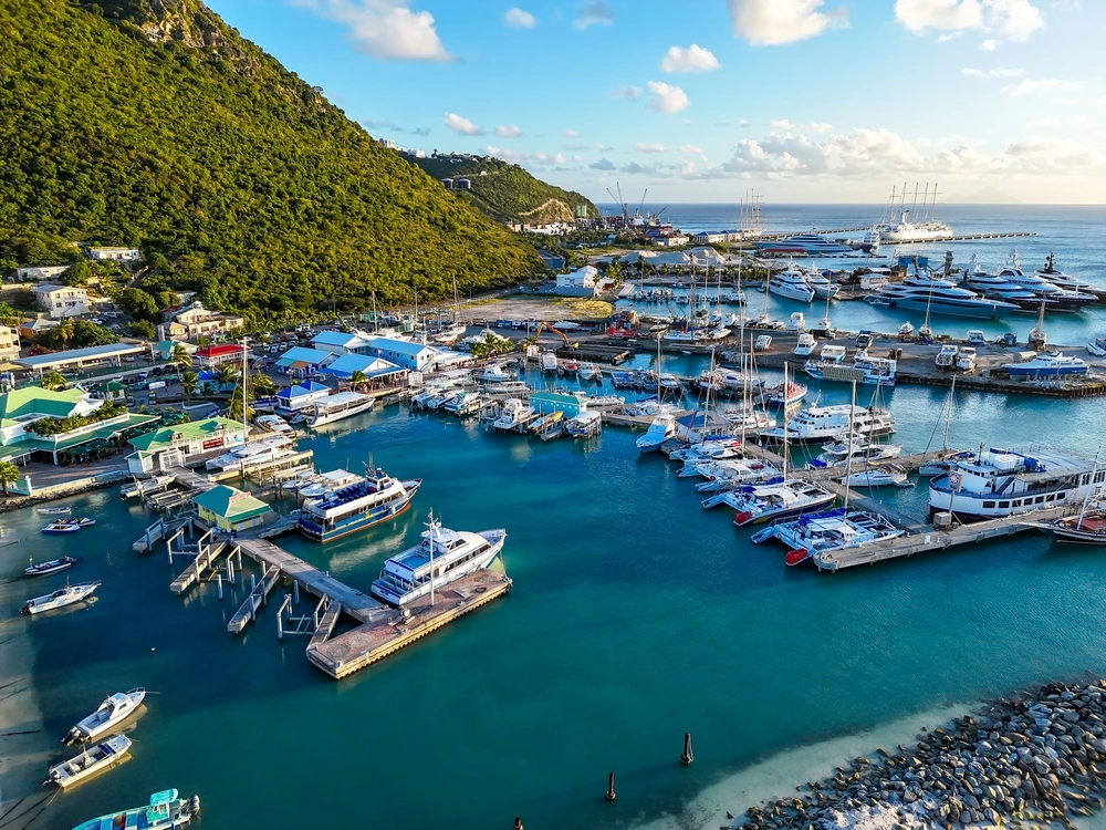 Marina in Sint Maarten on a sunny day with deep blue water and yachts docked